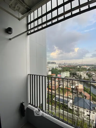 Stunning balcony view overlooking cityscape with modern railing and open sky.