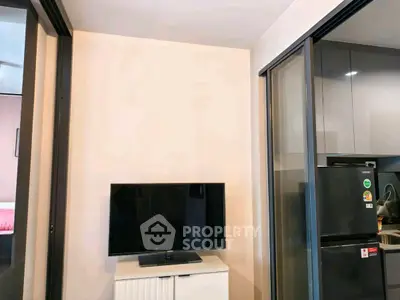 Modern apartment interior with TV and kitchen area