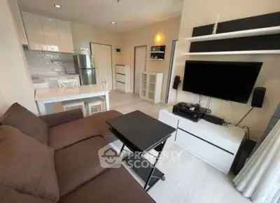 Modern living room with sleek furniture and open kitchen layout