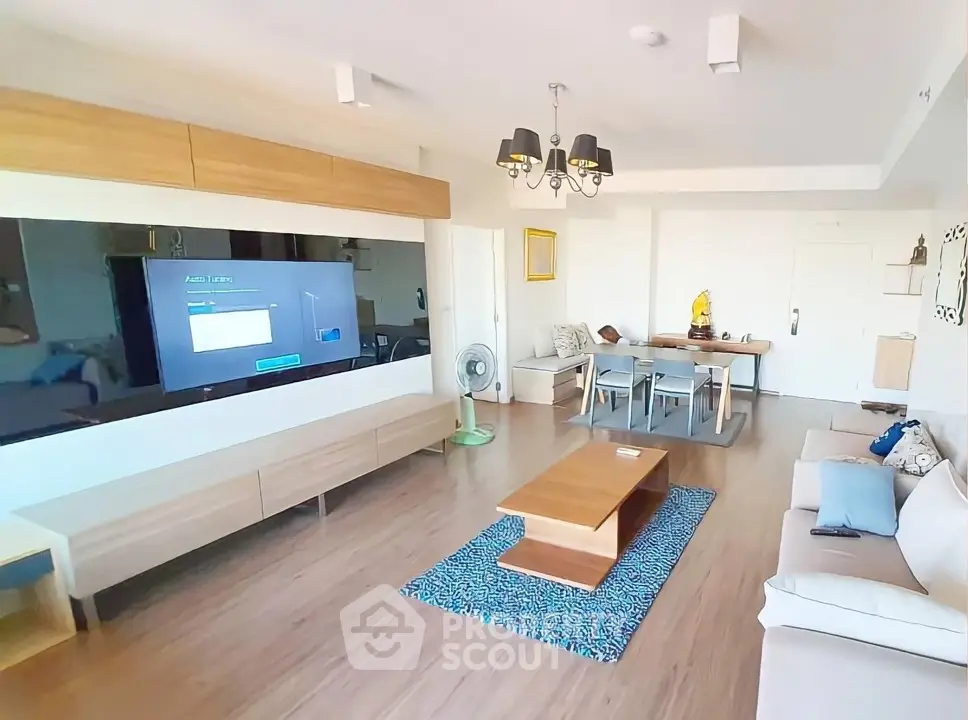 Spacious modern living room with wooden flooring and stylish furniture