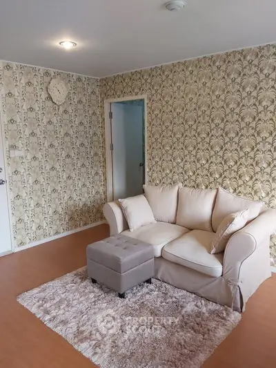 Charming living room with floral wallpaper and cozy beige sofa