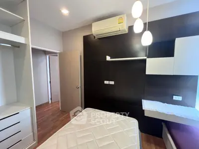 Modern bedroom with built-in storage and air conditioning unit