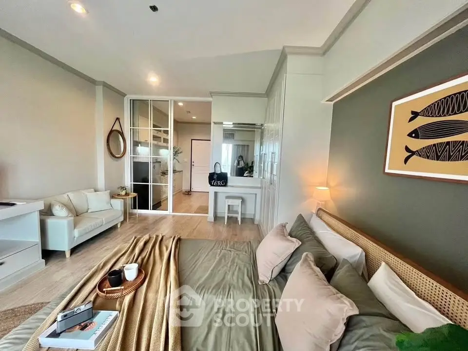 Spacious modern bedroom with elegant decor and cozy seating area