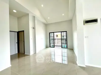 Spacious modern living room with high ceilings and large windows