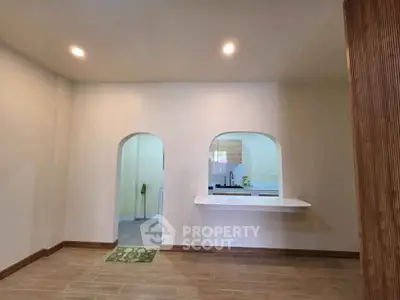 Spacious open-plan kitchen with modern design and wooden flooring, perfect for contemporary living.