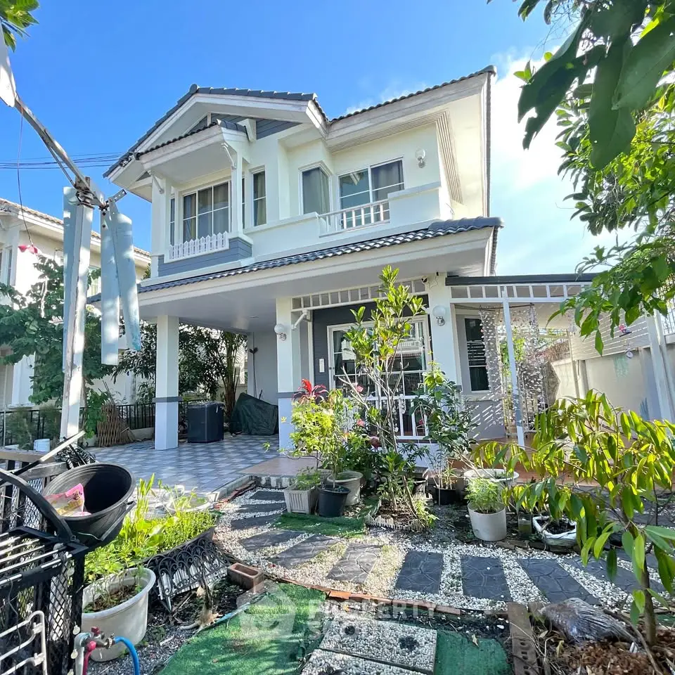 Charming two-story house with lush garden and spacious balcony, perfect for family living.