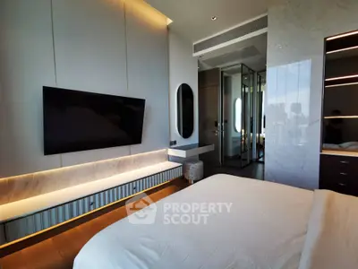 Luxurious modern bedroom with sleek design and city view, featuring a wall-mounted TV and elegant lighting.