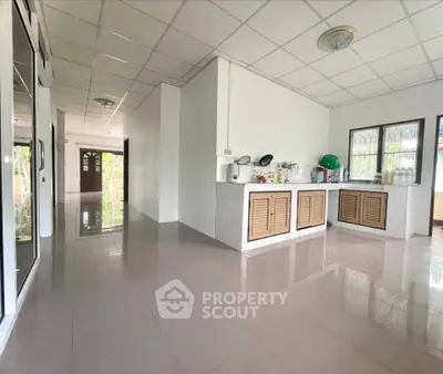 Spacious kitchen with closed layout and ample natural light in modern home.