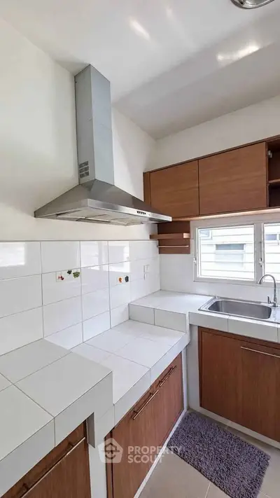 Modern kitchen with sleek cabinetry and stainless steel range hood