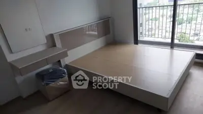 Modern bedroom with minimalist design and large window balcony view.
