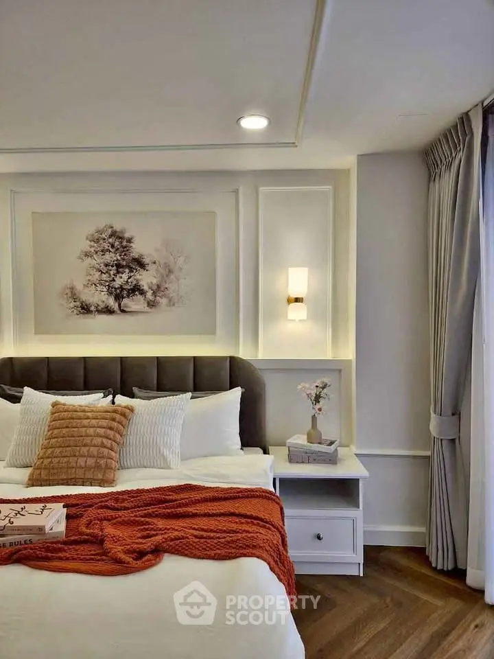 Elegant bedroom with modern decor, cozy bed, and stylish lighting in a luxurious apartment.