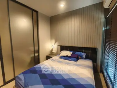 Cozy modern bedroom with stylish decor and ample natural light
