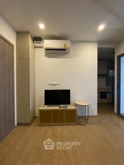 Modern living room with air conditioning and sleek wooden flooring