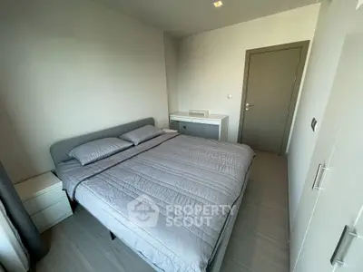 Modern minimalist bedroom with sleek design and neutral tones.