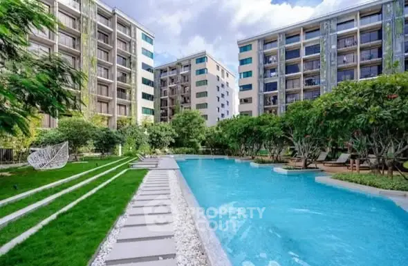 Luxurious apartment complex with stunning pool and lush gardens