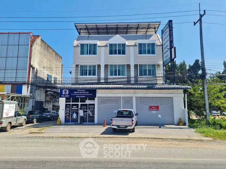 Modern commercial building with parking space and street view