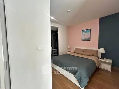 Cozy bedroom with modern decor and wooden flooring, featuring a comfortable bed and stylish lighting.