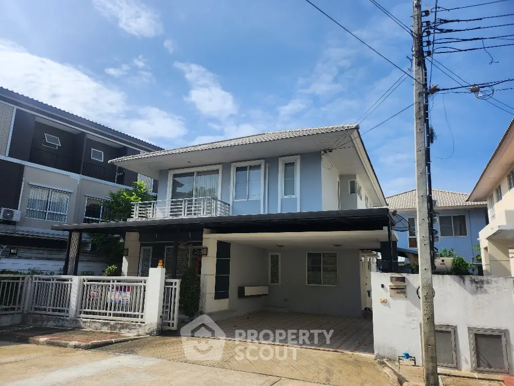 Modern two-story house with spacious driveway and contemporary design in suburban neighborhood.