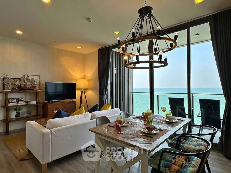 Stunning beachfront living room with elegant dining area and ocean view balcony.