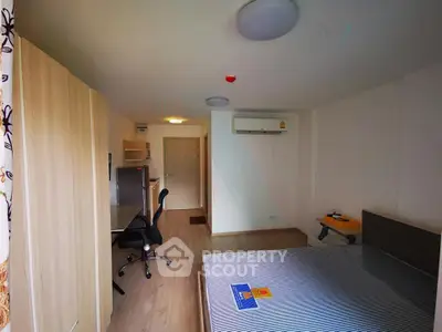 Modern bedroom with study area and air conditioning in a cozy apartment.