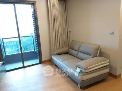 Modern living room with cozy sofa and balcony view in a stylish apartment.