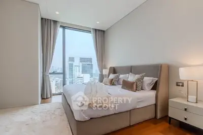 Luxurious bedroom with city view, elegant decor, and natural light.