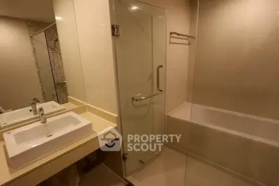 Modern bathroom with glass shower and bathtub in elegant design