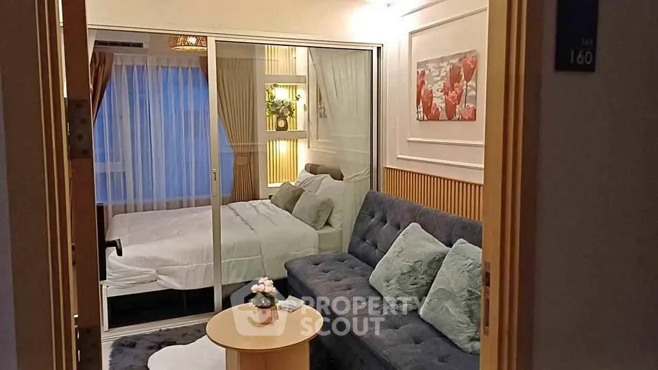 Chic modern bedroom with glass partition and cozy living area in stylish apartment
