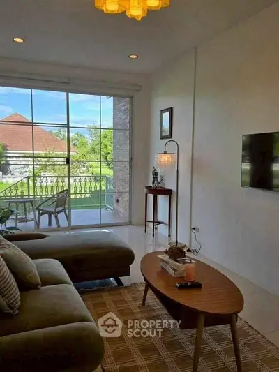 Charming living room with cozy seating and garden view, perfect for relaxation and entertaining.