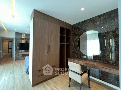 Luxurious bedroom with elegant wood finishes and stylish mirror