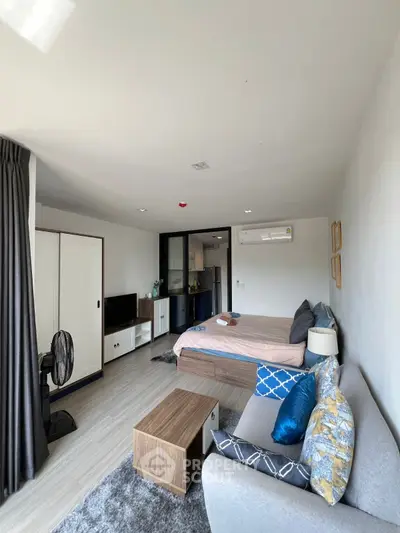 Spacious modern bedroom with cozy seating area and stylish decor