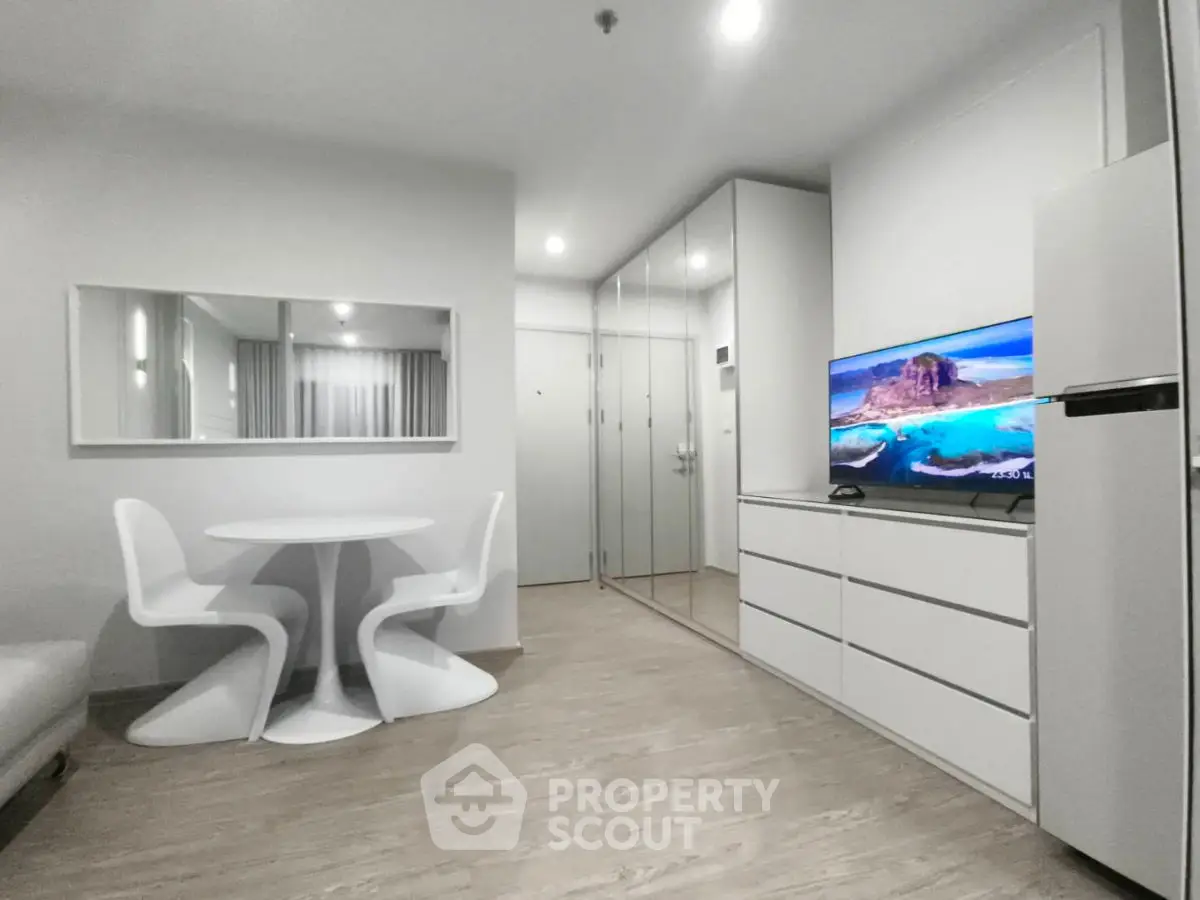 Modern living room with sleek furniture and mirrored closet doors