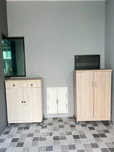Modern storage area with sleek cabinets and tiled floor