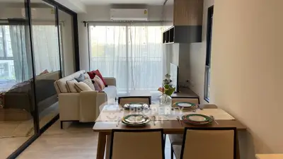 Modern open-plan living and dining area with stylish decor and natural light.