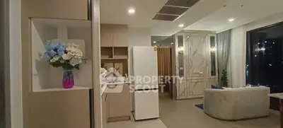 Modern open-plan living room with stylish decor and elegant lighting