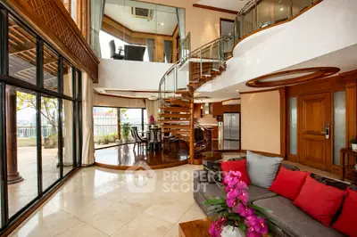 Luxurious open-plan living room with spiral staircase and modern decor, perfect for upscale living.