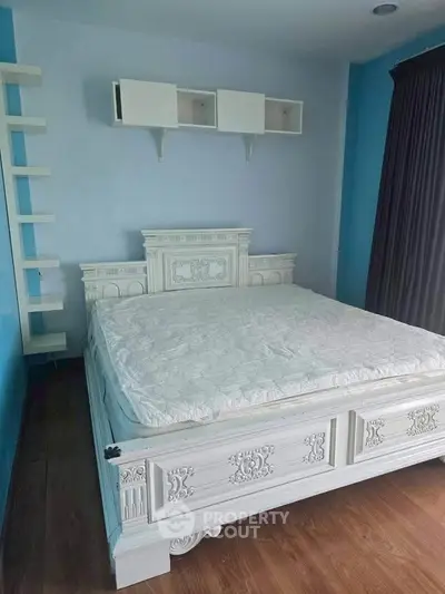 Elegant bedroom with ornate white bed and blue walls, perfect for a cozy retreat.