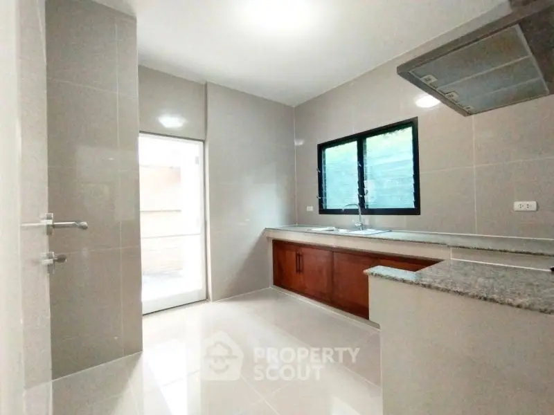 Modern kitchen with sleek countertops and ample natural light