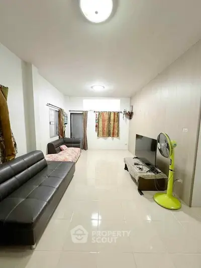 Spacious living room with modern furniture and bright lighting