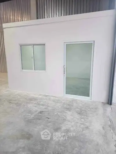 Modern industrial unit with sleek design and secure entry, perfect for business operations.