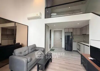 Modern loft apartment with mezzanine, sleek kitchen, and stylish living area.