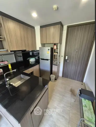 Modern kitchen with sleek cabinetry and stainless steel appliances in a compact layout.