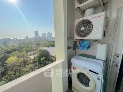 High-rise balcony with washing machine and city view, perfect for urban living.