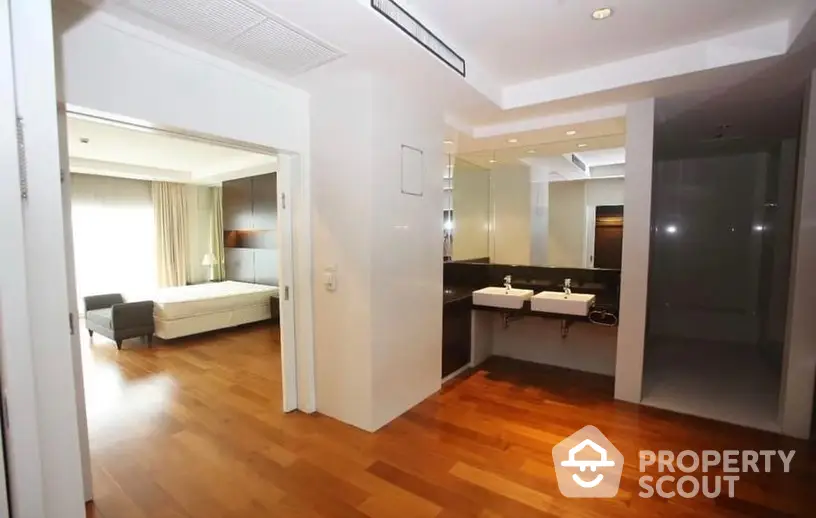 Spacious multi-room apartment with gleaming hardwood floors and modern design, featuring an open layout and ample natural light.