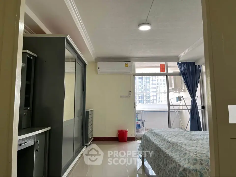 Spacious bedroom with balcony view in modern apartment