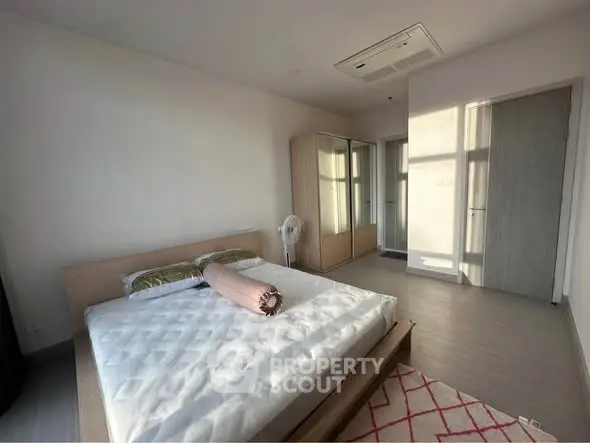 Spacious bedroom with modern design and ample natural light