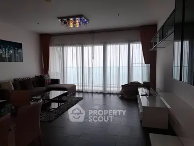 Modern living room with stylish decor and large windows offering natural light.