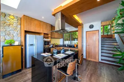 Modern kitchen with island, stainless steel appliances, and wooden cabinetry.