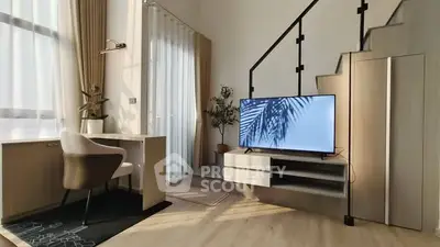 Modern living room with stylish staircase and natural light