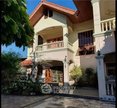 Charming two-story house with spacious balcony and lush garden, perfect for family living.